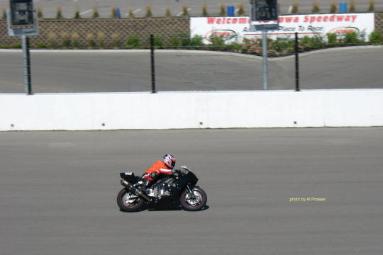 Chase Rider between turn one and two with Iowa Speedway sign